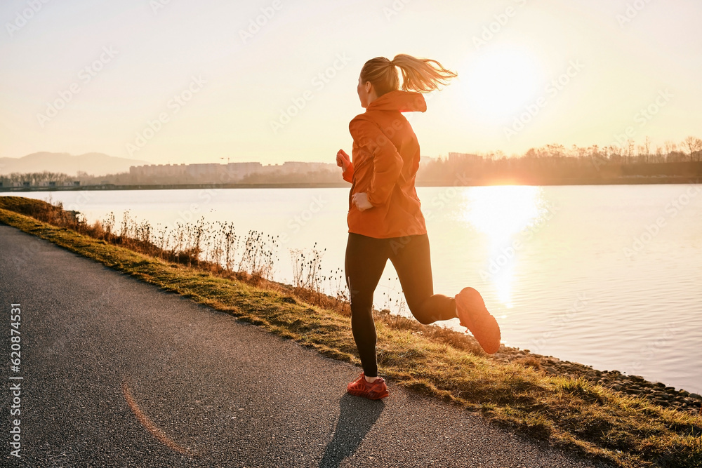 Woman running outdoors. Healthy lifestyle concept, people go in sports. Silhouette family at sunset.