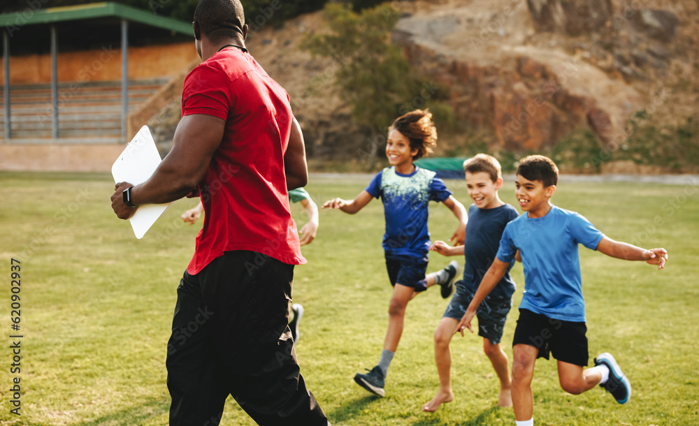 Coach training kids in a school ground