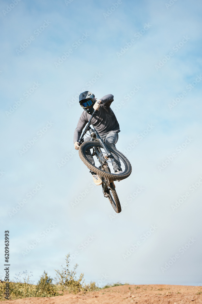 Mountain, bike jump and person cycling on bicycle for extreme sports competition stunt or training i