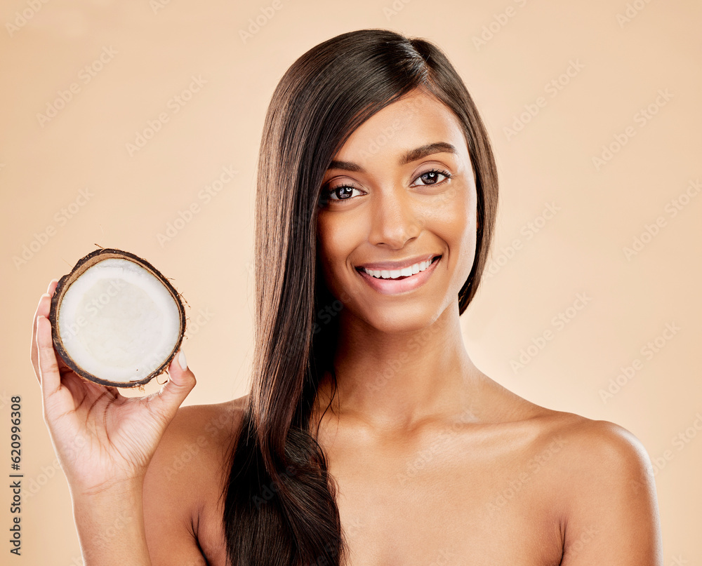 Portrait, woman and coconut for hair, beauty or cosmetic treatment for natural skincare on studio ba