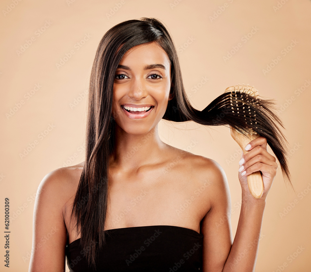 Portrait, beauty and a woman brushing her hair in studio on a cream background for natural or luxury