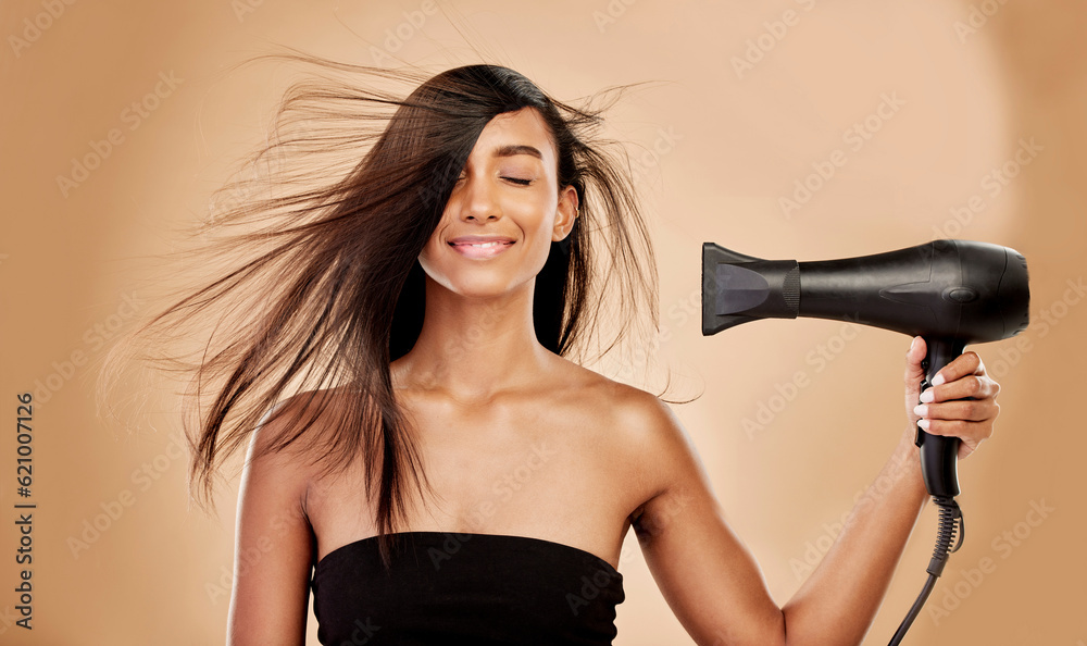 Hair, dryer and smile of woman in studio for beauty, grooming and heat equipment on background. Indi