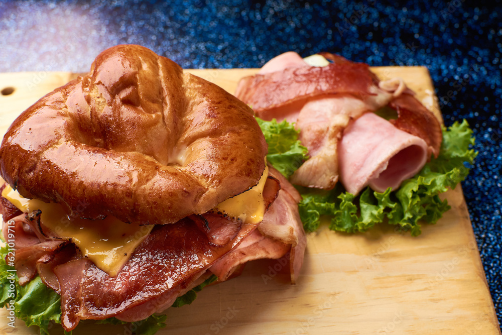 Little croissant with ham, bacon, yellow cheese and orejona lettuce, still sided with a roll of ham,