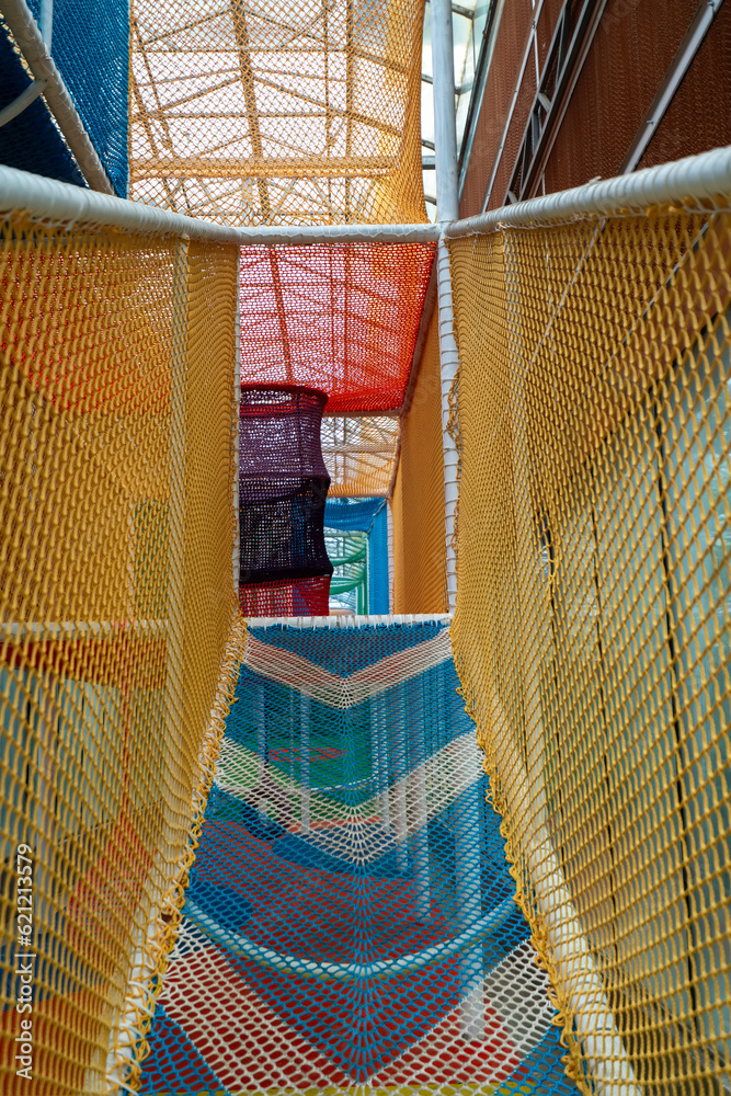  An outdoor colorful playground next to the house. A summer day.