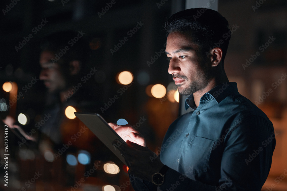 Night, work or man reading on tablet for research, project or planning a proposal in office building