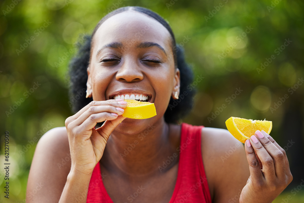 Black woman, vitamin C and eating orange slice for natural nutrition or citrus diet in nature outdoo