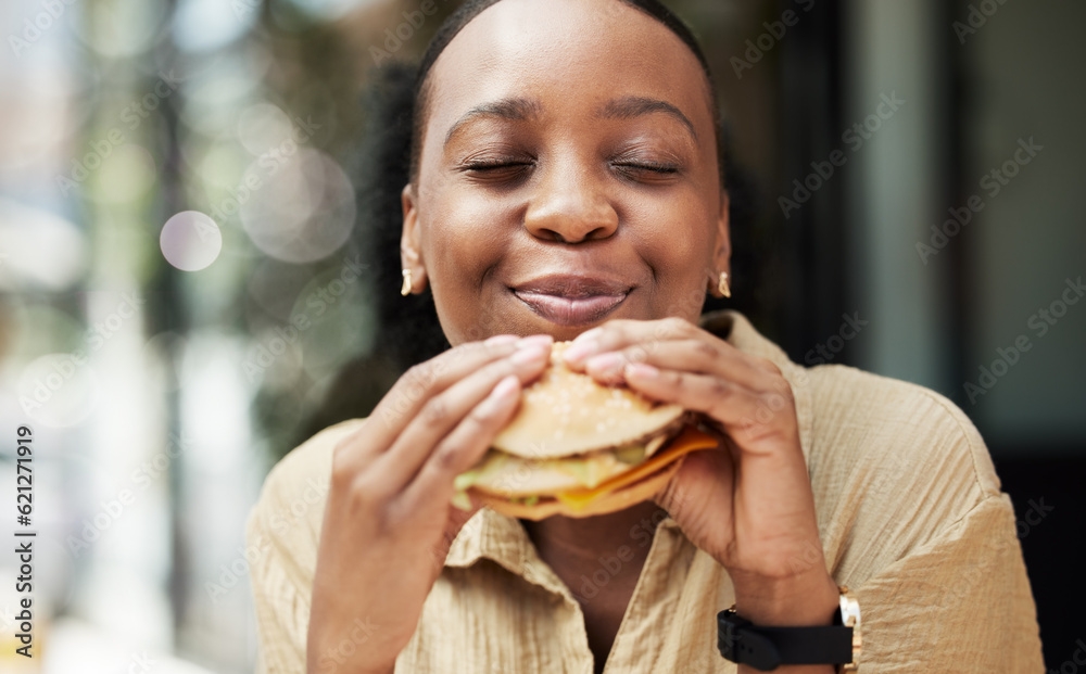 Restaurant, fast food and black woman eating a burger in an outdoor cafe as a lunch meal craving dea