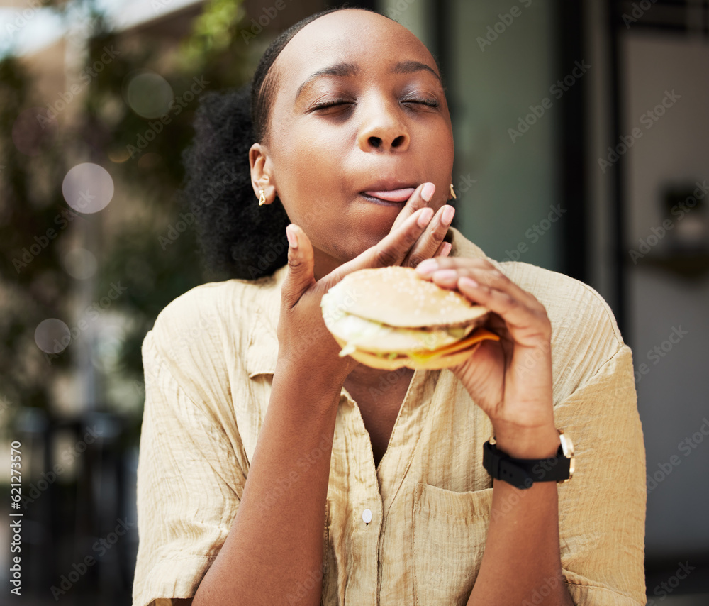 Hamburger, fast food and black woman eating a brunch in an outdoor restaurant as a lunch meal cravin