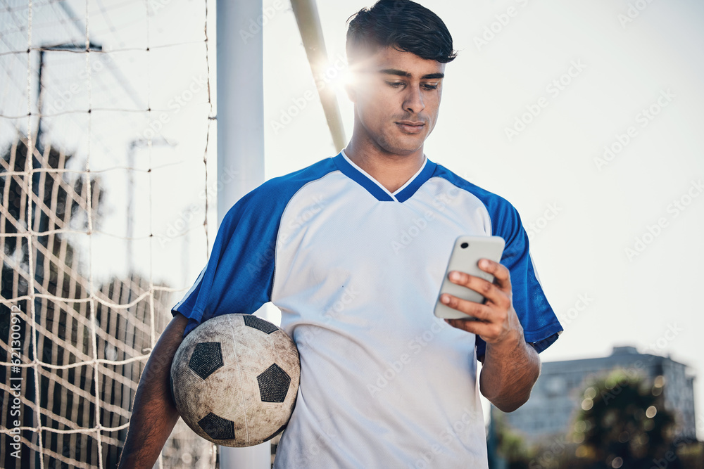 Soccer ball, phone and man on field for competition, training or fitness news, social media chat and