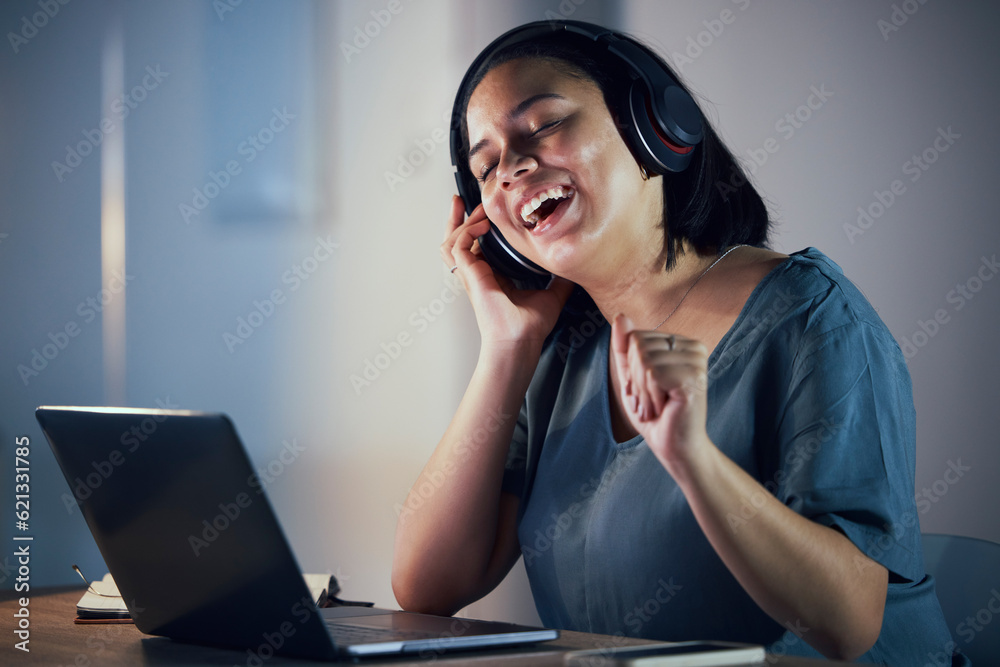 Happy woman, headphones and listening to music at night for online audio streaming on office desk. F