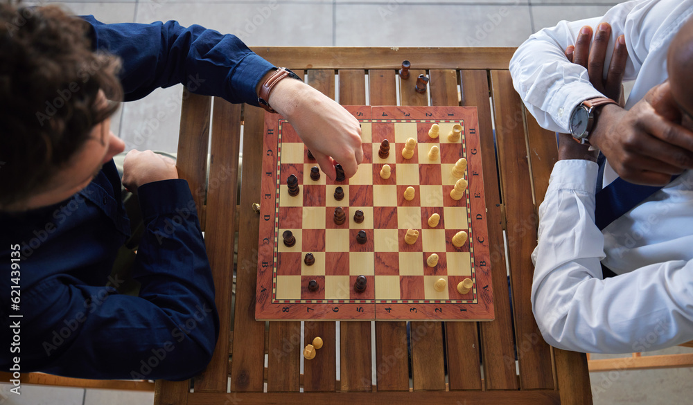 Chess, board game and business men playing at a table from above while moving piece for strategy. Ma