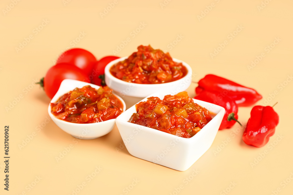 Composition with bowls of salsa sauce, bell peppers and tomatoes on color background