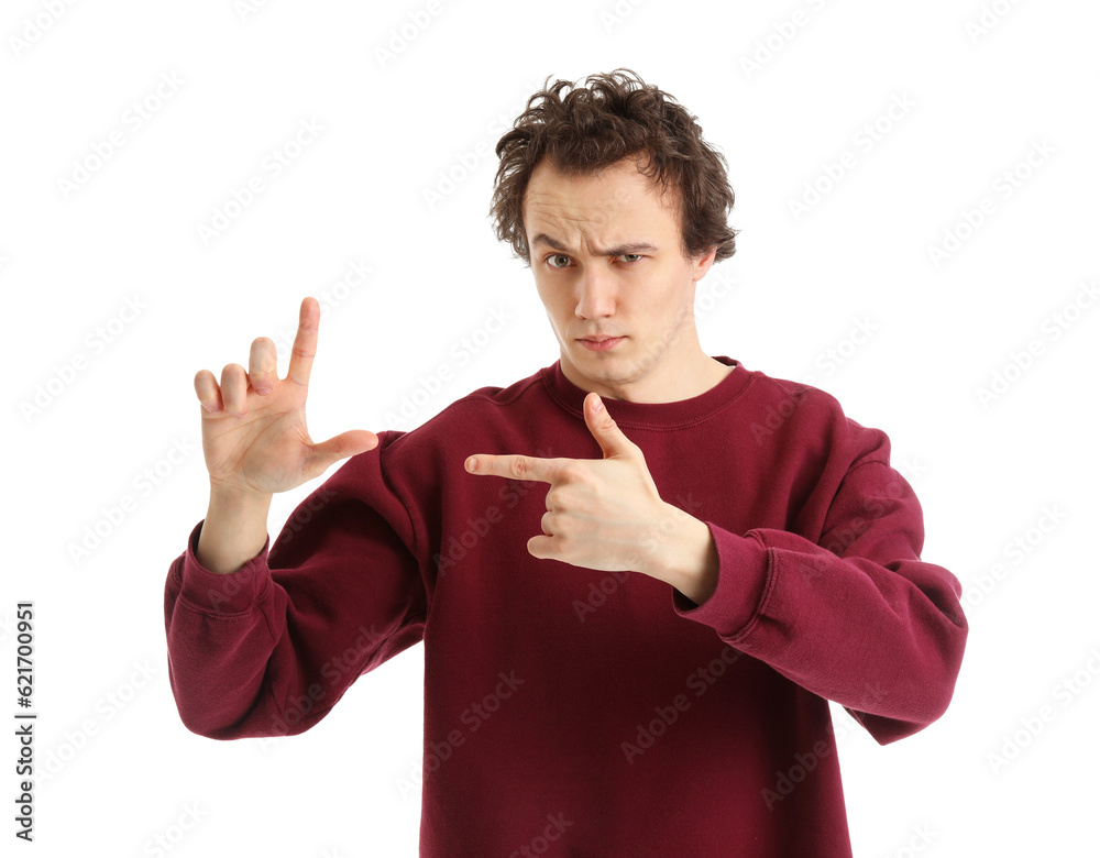 Shocked young man showing loser gesture on white background