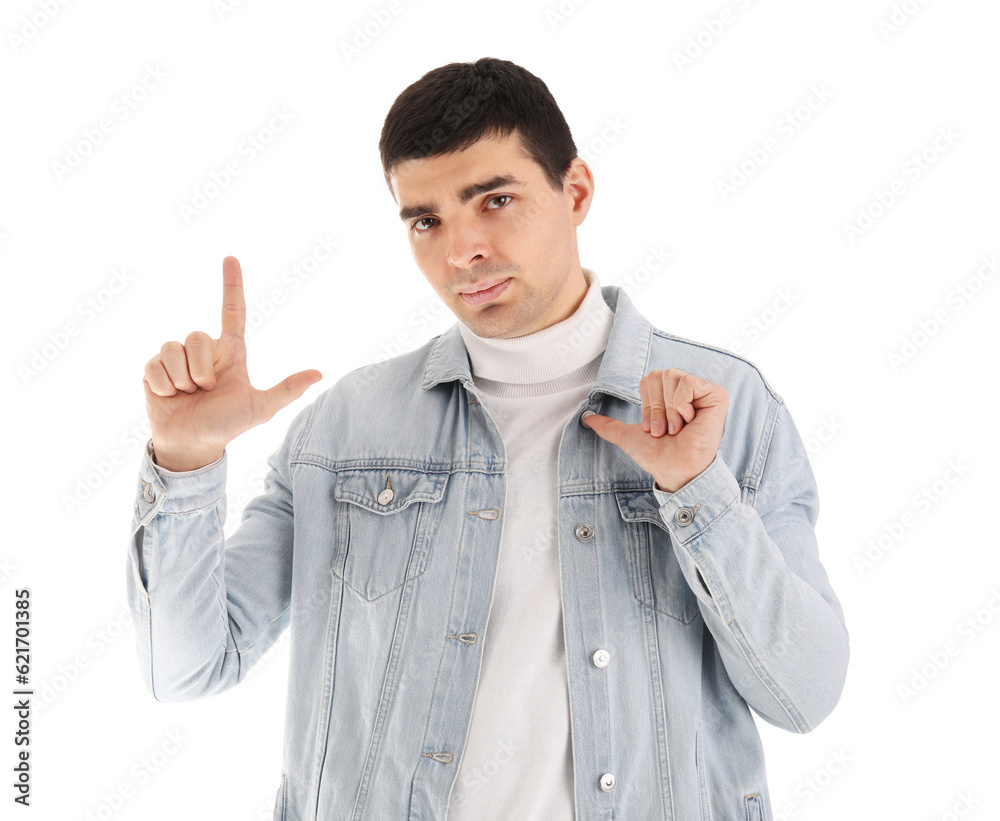 Upset young man showing loser gesture on white background