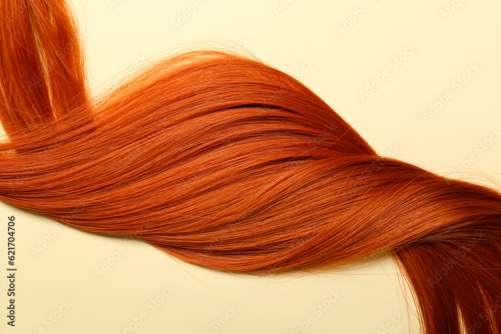 Ginger hair strand on color background, closeup