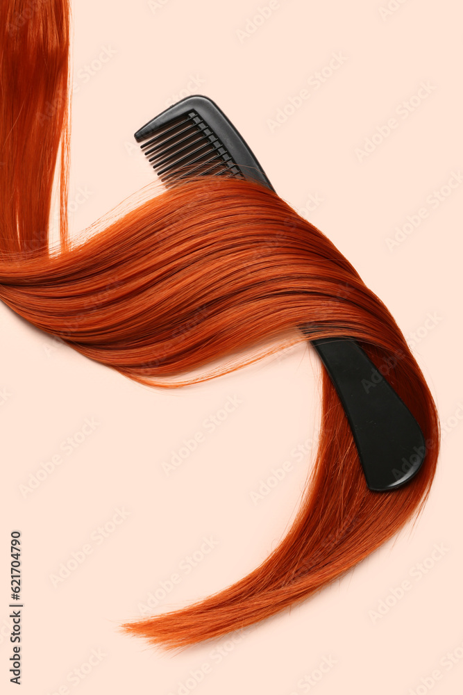 Ginger hair strand with comb on color background, closeup