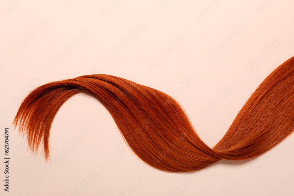 Ginger hair strand on color background, closeup