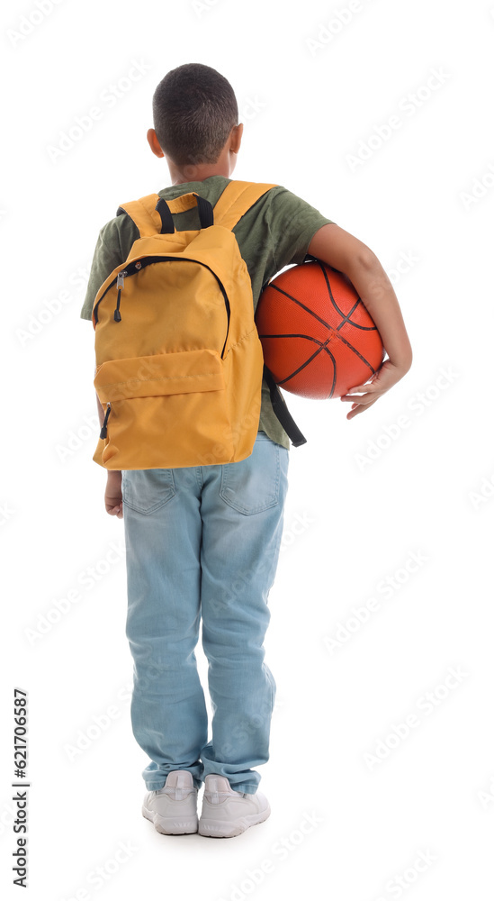 Little African-American schoolboy with ball and backpack on white background, back view