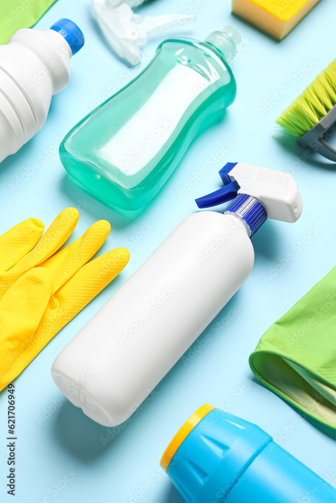 Different cleaning supplies on blue background