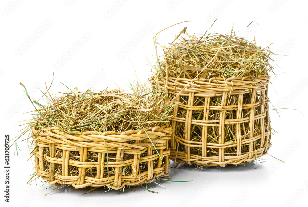 Straw in baskets on white background