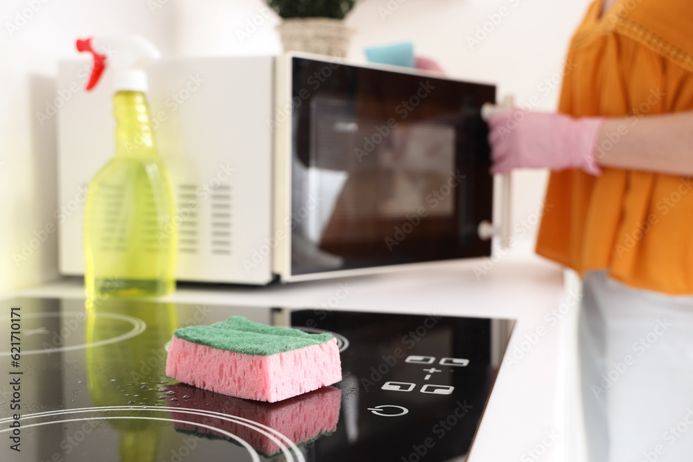 Cleaning sponge on electric stove in kitchen, closeup