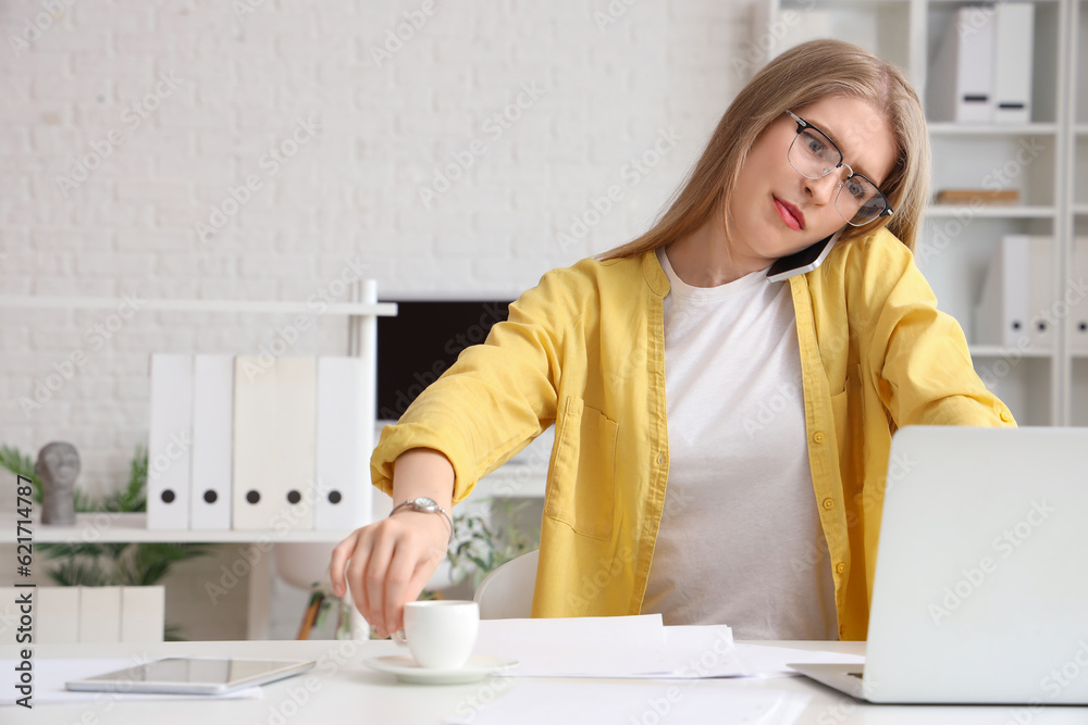 Young businesswoman working under deadline in office