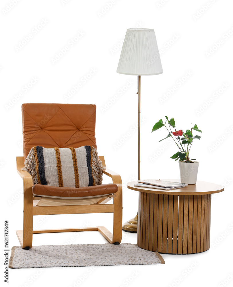 Cozy armchair with table, lamp and rug on white background