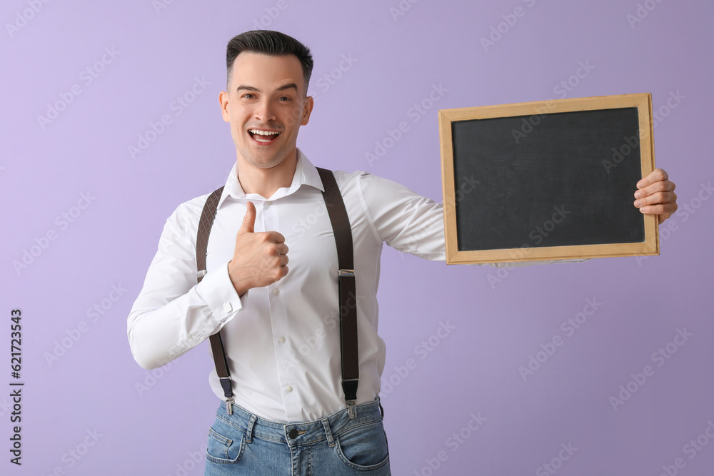 Male teacher with chalkboard showing thumb-up on lilac background