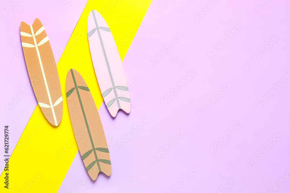 Different mini surfboards on color background