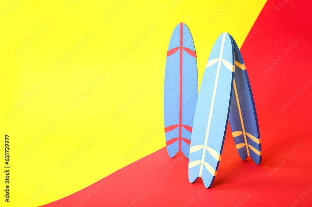 Mini surfboards on color background