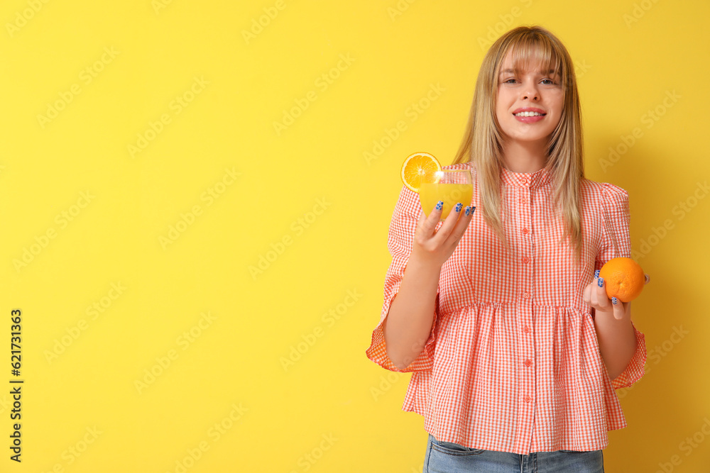 Teenage girl with glass of juice and orange on yellow background