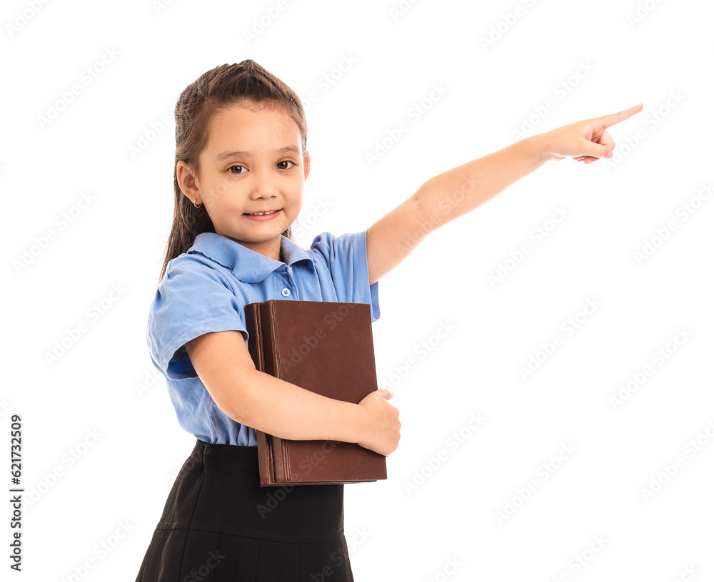 Little schoolgirl with book pointing at something on white background