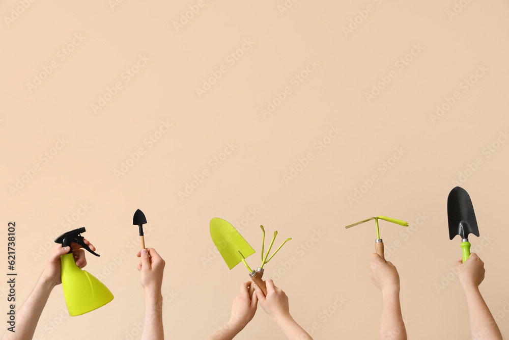 People with gardening tools on beige background