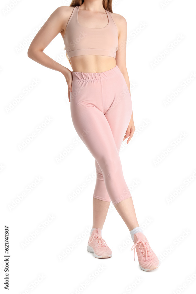 Young woman in sportswear on white background