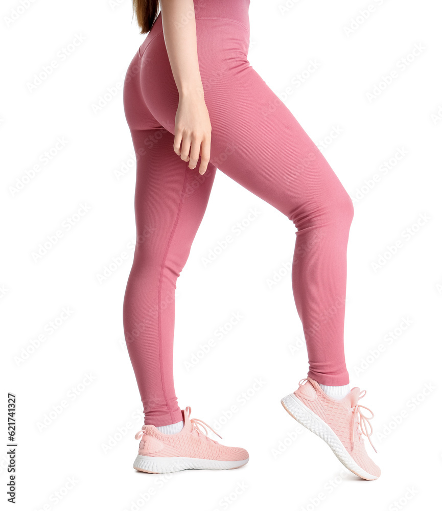 Sporty young woman in leggings on  white background