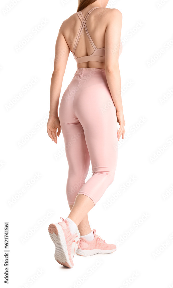 Young woman in sportswear on white background