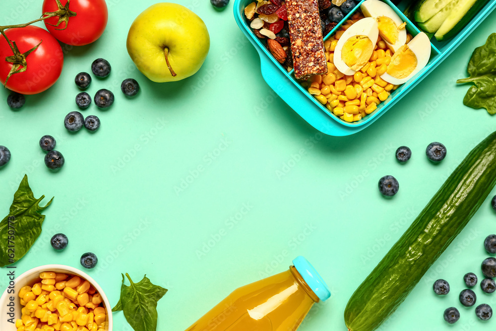 Frame made of fruits, vegetables and lunchbox with tasty food on turquoise background