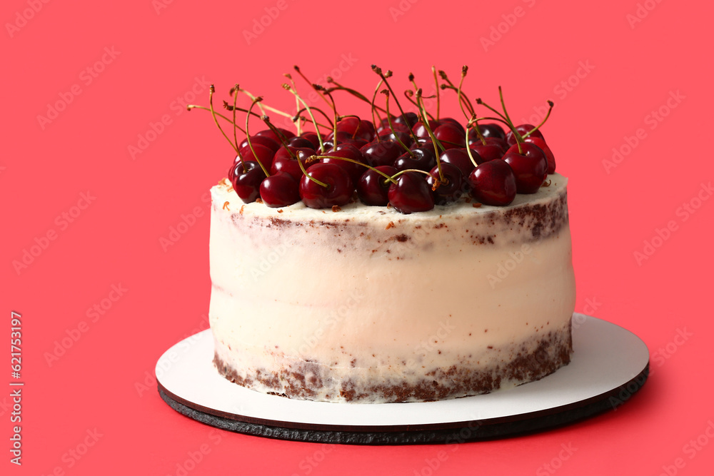 Board with tasty cherry cake on color background