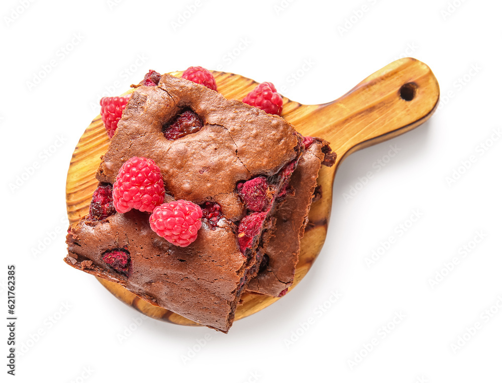 Wooden board with pieces of raspberry chocolate brownie on white background