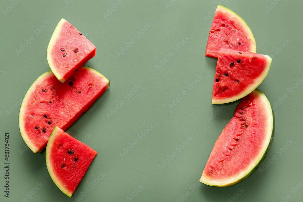 Pieces of fresh watermelon on green background