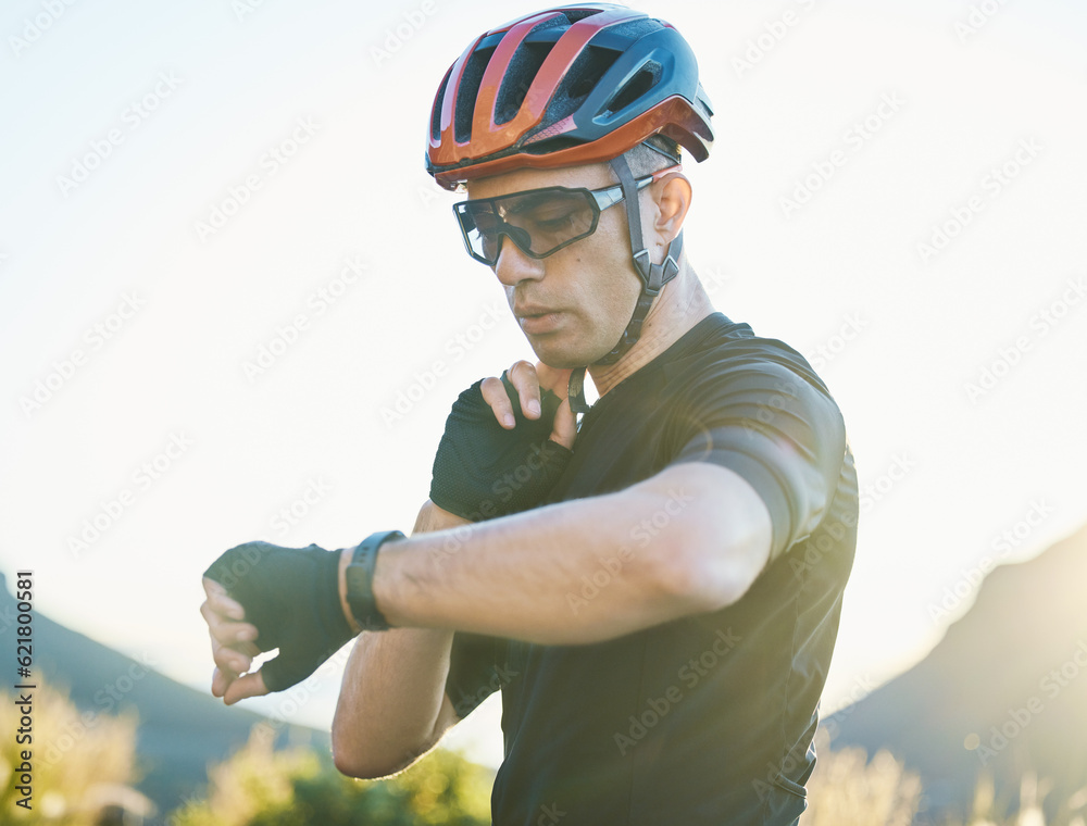 Watch, nature and cyclist checking his pulse while cycling for fitness or exercise on a mountain. Sp