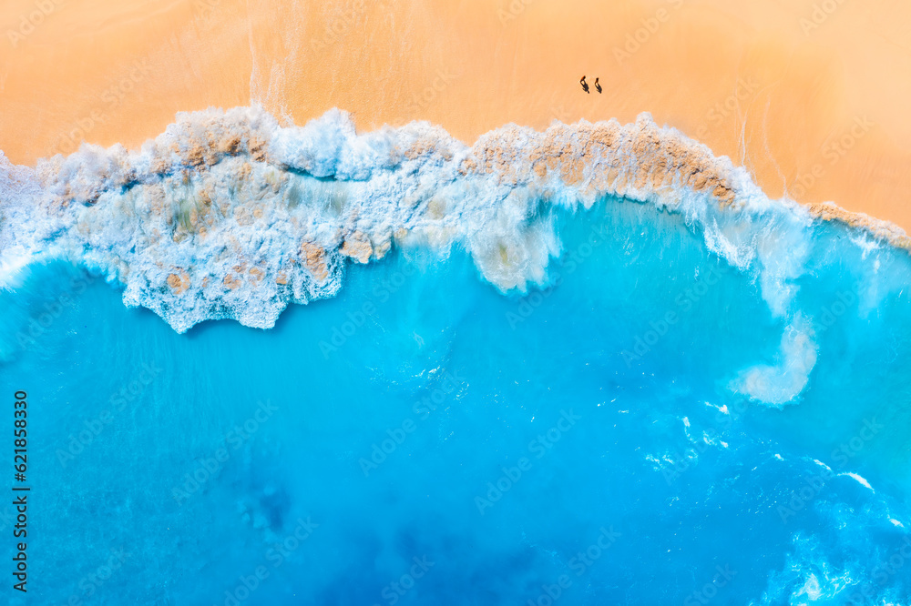 An aerial view of the people on the beach. Coast as a background from top view.  Waves and beach. Se