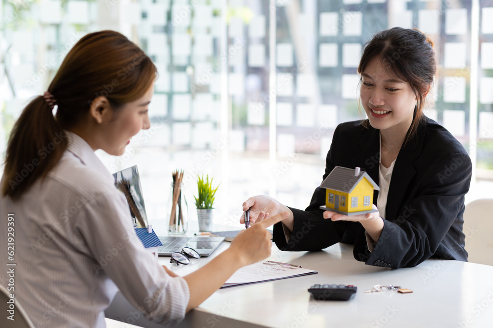 Businesswoman, real estate agent discussing the terms of the house purchase agreement contract docum