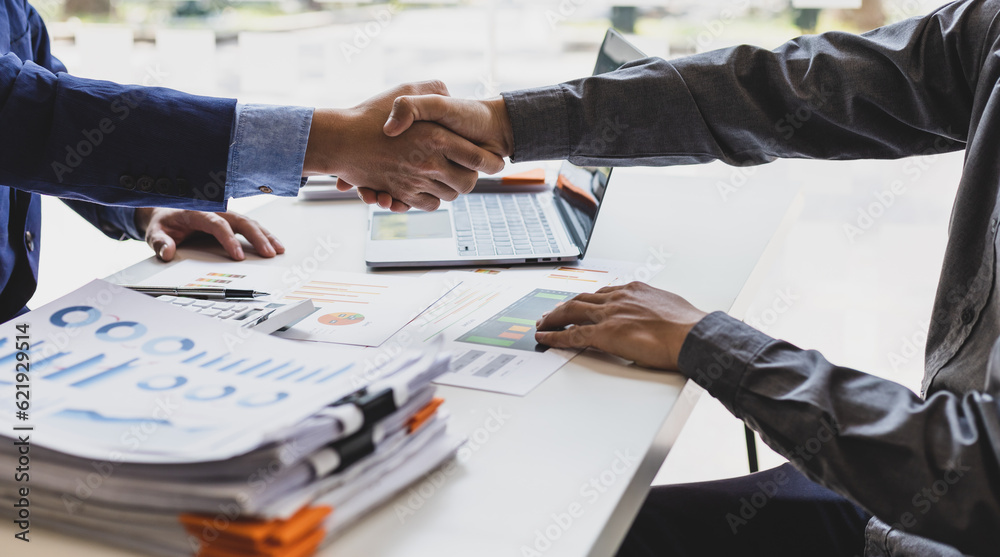 Business people shaking hands in a successful financial and investment cooperation meeting.