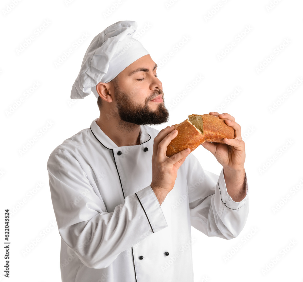 Male baker with fresh bread on white background