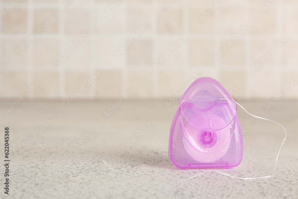 Case with dental floss on table, closeup