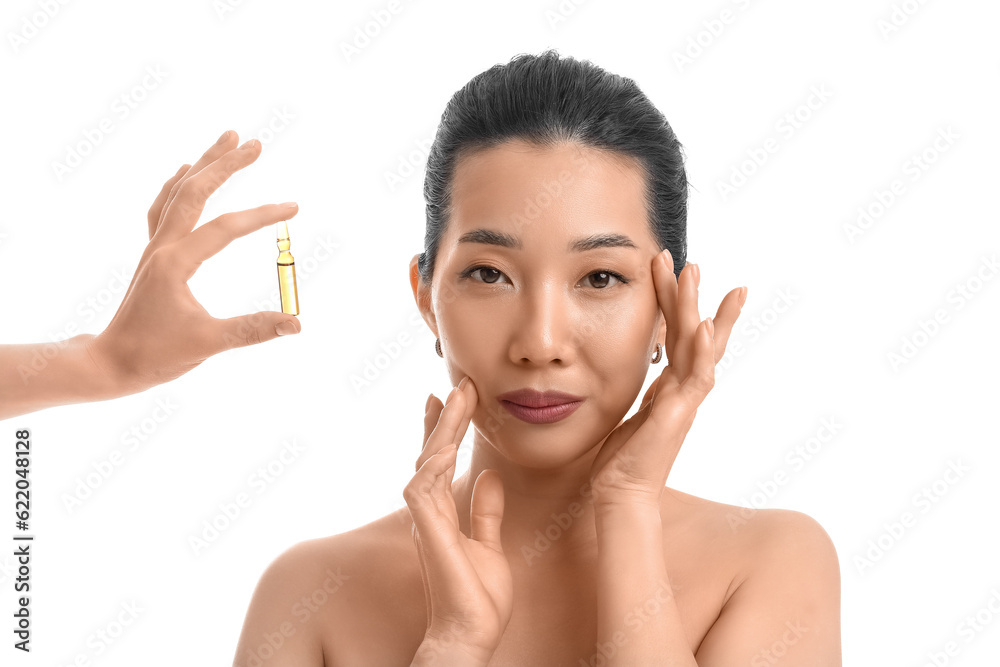 Beautiful Asian woman and hand with ampule on white background. Skin care concept