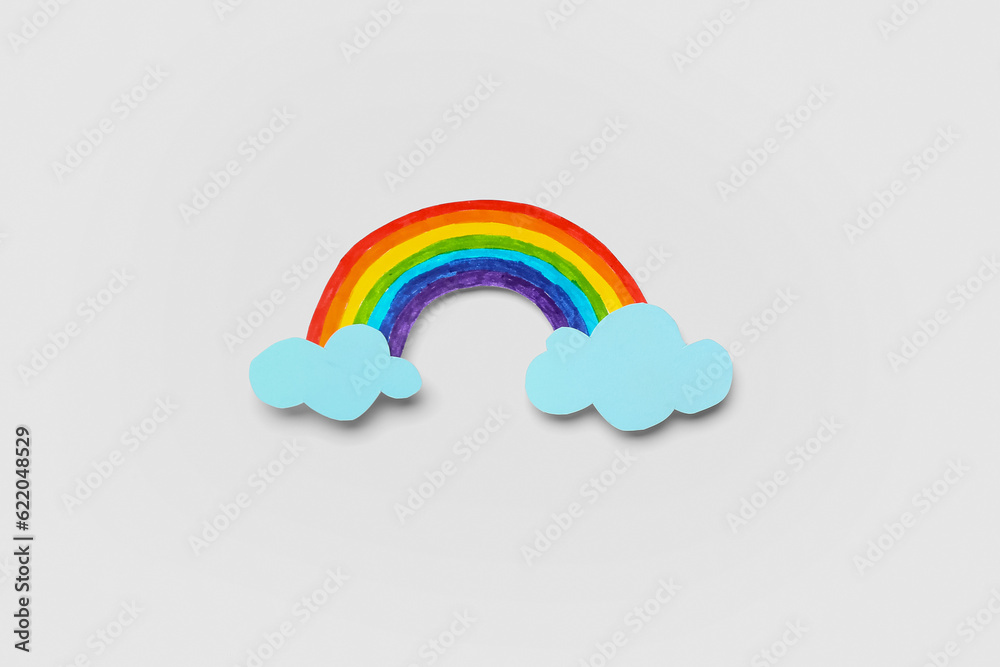 Paper rainbow on white background. Weather forecast concept