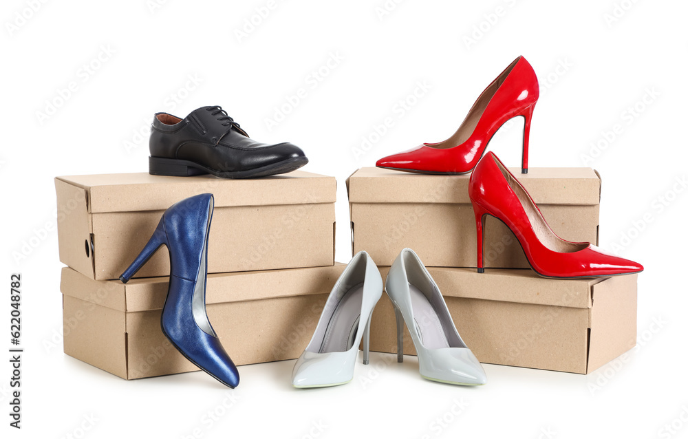 Cardboard boxes with different shoes on white background