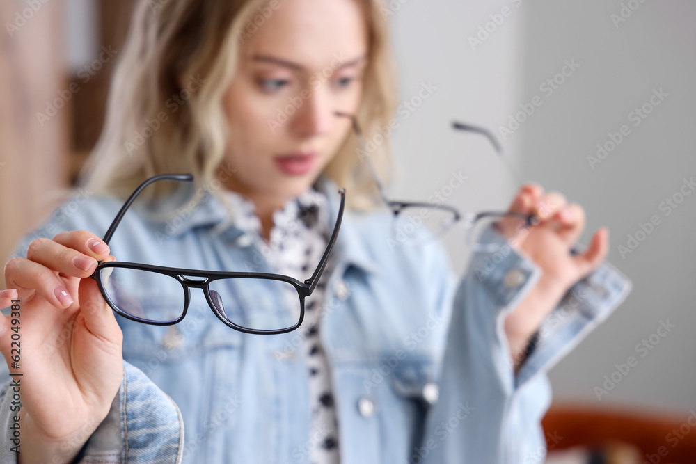 Young woman with stylish eyeglasses at home, closeup